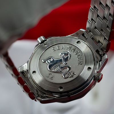 Omega Seamaster 212.30.41.20.01.002 caseback featuring the embossed Seamaster hippocampus logo and text.