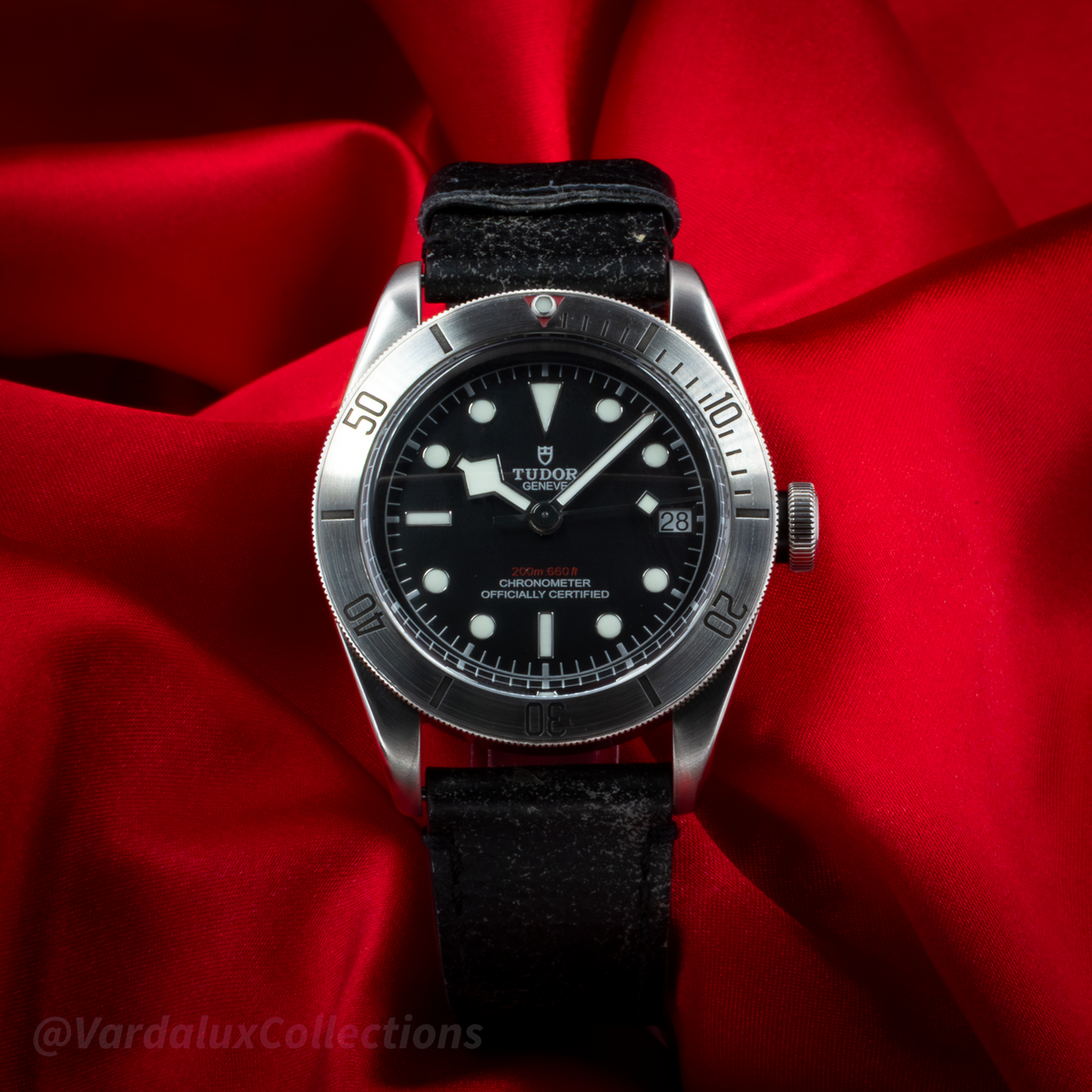 Tudor Black Bay 79730-0005, a full-face shot of the black dial and silver case with a black leather strap.
