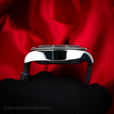 Tudor Black Bay 79730-0005 case profile with polished sides and fluted bezel, held by gloved hand.