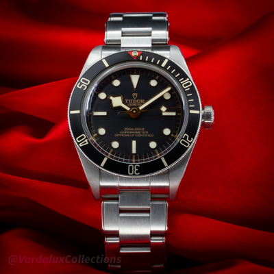 Tudor Black Bay Fifty-Eight M79030N-0001, full dial view with stainless steel bracelet on red background.