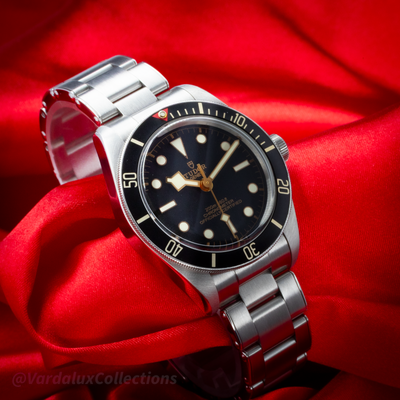 Tudor Black Bay Fifty-Eight M79030N-0001, full dial and bracelet view on red fabric.