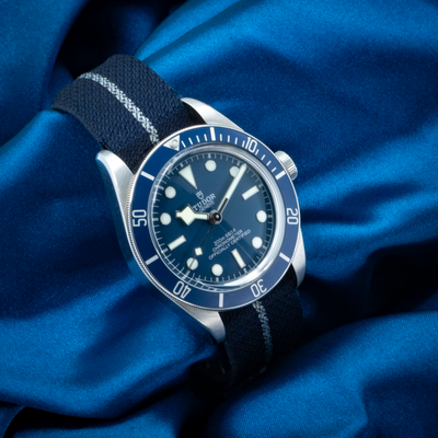 Tudor Black Bay Fifty-eight Blue M79030B-0003 watch with blue dial and fabric strap on blue silk.