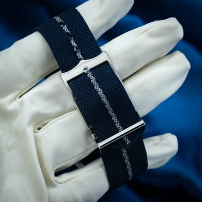 Tudor Black Bay Fifty-eight Blue M79030B-0003, navy blue NATO strap and silver buckle on gloved hand.