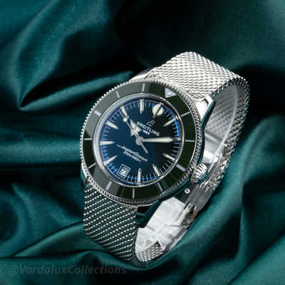 Breitling SuperOcean Heritage B31 AB31100361L1A1 with blue dial, date display, bezel, crown, and Milanese bracelet.