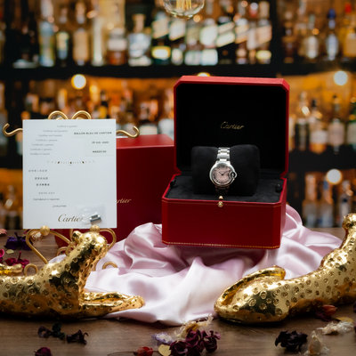 Cartier Ballon Bleu W6920100 watch and documentation, with the pink dial visible in its red presentation box.
