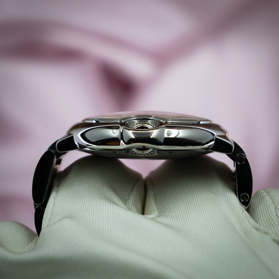 Cartier Ballon Bleu W6920100 watch, side view of polished steel case and crown on a white gloved hand.