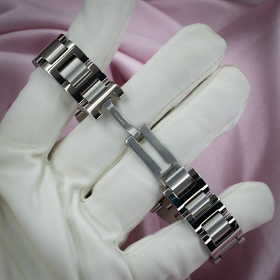 Cartier Ballon Bleu W6920100 watch, stainless steel bracelet and deployment clasp on a gloved hand.