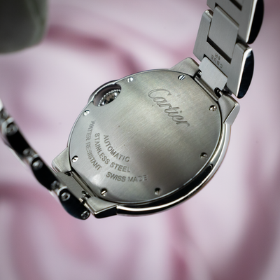Cartier Ballon Bleu W6920100 caseback, engraved with "Cartier," "AUTOMATIC," "STAINLESS STEEL," and "SWISS MADE."