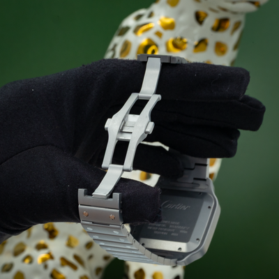 Cartier Santos WSSA0089 caseback and clasp held by a gloved hand.