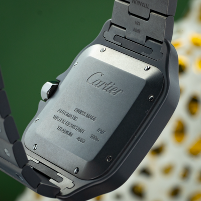 Cartier Santos WSSA0089 caseback with "Cartier" engraved and visible "Swiss Made" and "Automatic" text.