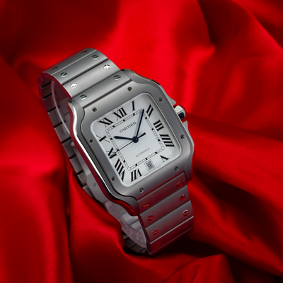 Cartier Santos WSSA0089 watch, close-up of the white dial with Roman numerals and blue hands.