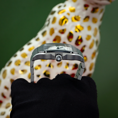 Cartier Santos WSSA0089 side view of the crown and bracelet, with black textile and leopard figure.
