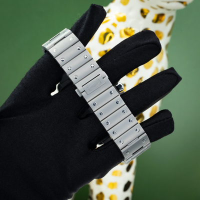 Cartier Santos WSSA0089, watch bracelet and clasp on black gloved hand.