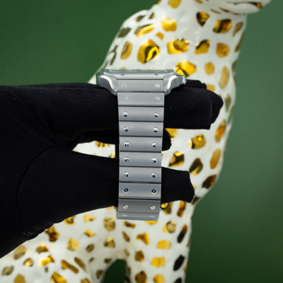 Cartier Santos WSSA0089 case and bracelet side view on gloved hand.