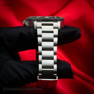 Tudor Pelagos 25600TN watch side profile showing crown, bezel, and bracelet on a black display.