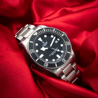 Tudor Pelagos 25500TN, dial and bracelet in brushed titanium on red satin.