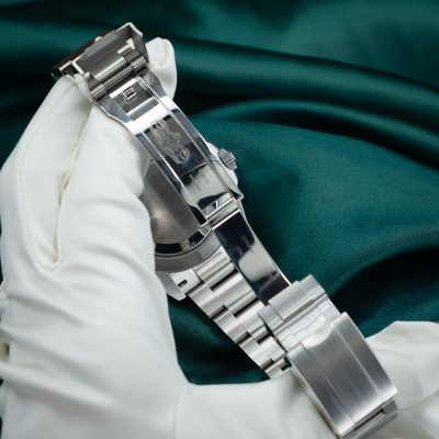 Rolex Air King Automatic Black Dial 126900 clasp with engraved logo, held by a gloved hand.