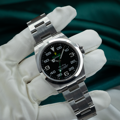 Rolex Air King Automatic Black Dial 126900 dial and bracelet on a gloved hand.