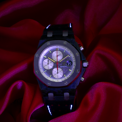 Audemars Piguet Jarno Trulli 26202AU.OO.D002CA.01, close-up of the grey chronograph dial on red fabric.