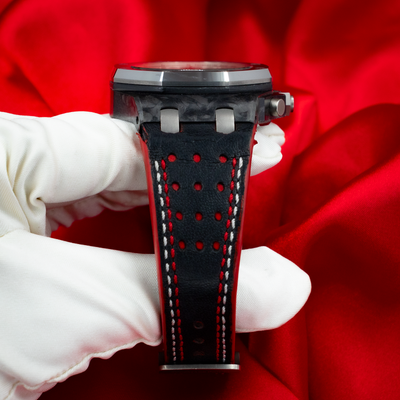 Audemars Piguet Jarno Trulli 26202AU.OO.D002CA.01, wrist shot showing the black perforated strap with red and white