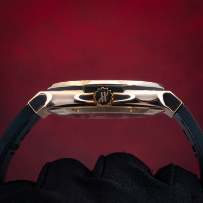 Hublot Gold Skeleton 505.OX.0180.LR, view of the rose gold case side, crown, and black rubber strap.